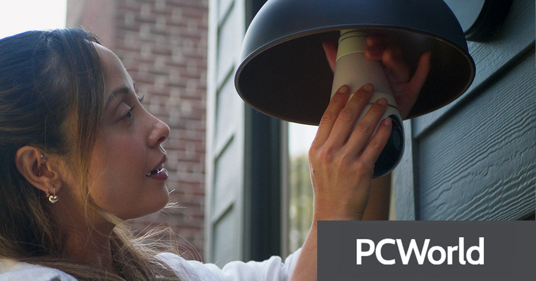 Woman installing Lorex smart lighbulb wi-fi security camera