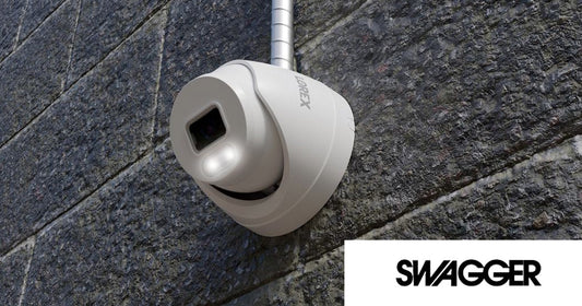 Lorex Connect T Series turret security camera mounted on a stone wall, featured in SWAGGER Magazine