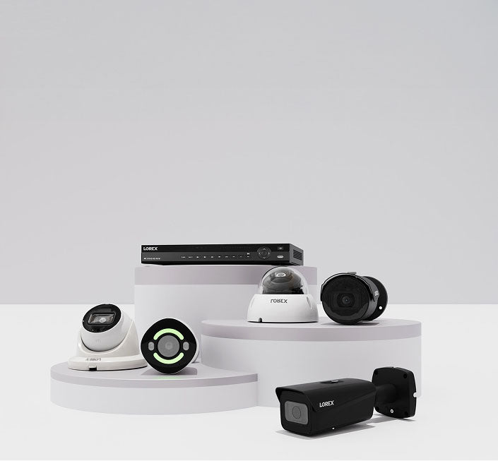 Collection of Lorex professional wired security cameras and NVR recorder, including dome, bullet, and turret cameras displayed on white podiums.